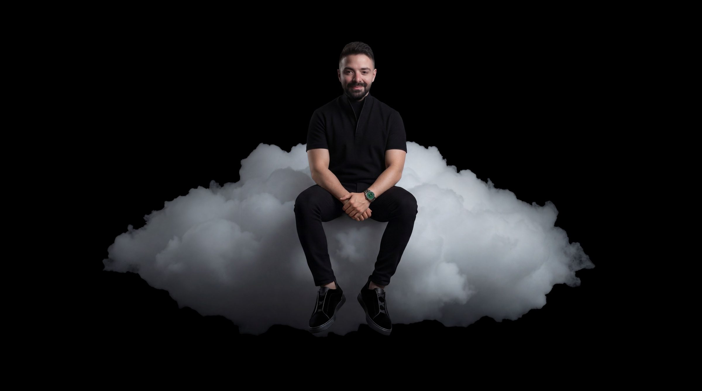 Charles Nasr sitting on a cloud